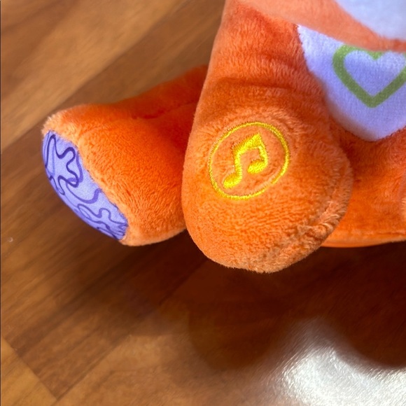 Orange and Blue Stuffed Raccoon Toy with Cartoonish Design - Picture 5 of 8